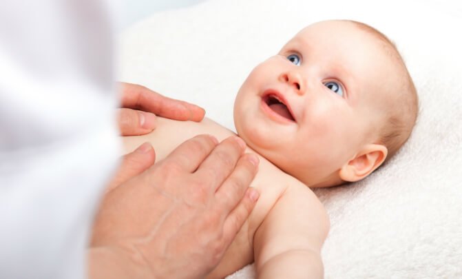 Craniosacral fascial therapy provider works with a baby with lateral arm rotation