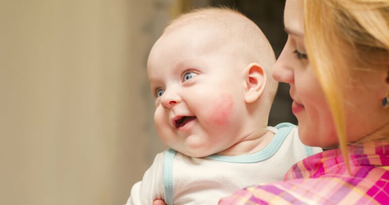 Mother holds happy baby - Gillespie Approach–Craniosacral Fascial Therapy