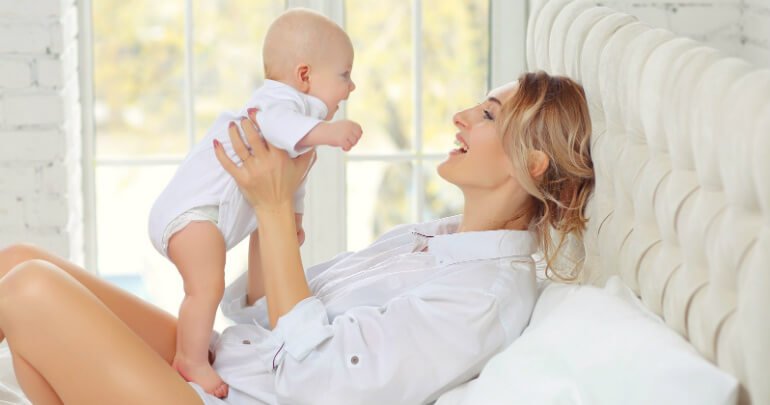 mother raises a happy baby in bed - strong immune system - Gillespie Approach–Craniosacral Fascial Therapy