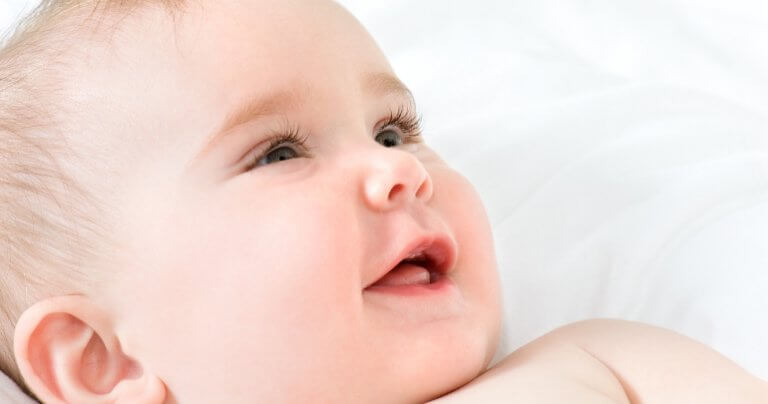 Baby smiling in closeup - concept of energetics in Gillespie Approach–Craniosacral Fascial Therapy