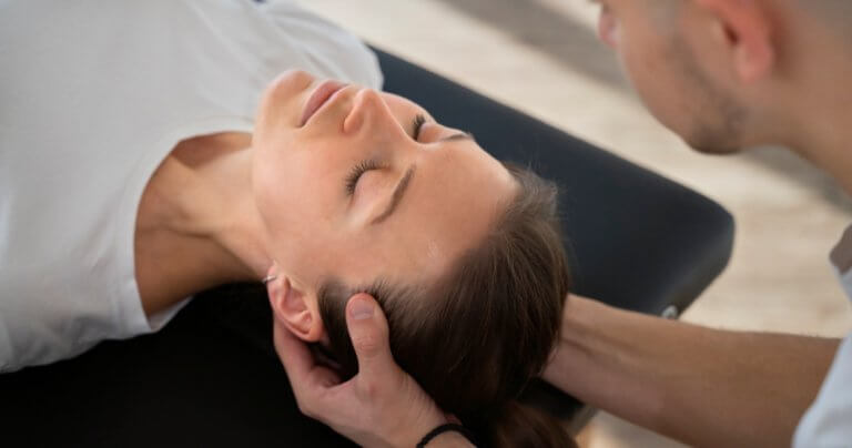 Message for Gillespie Approach students - closeup of therapist holding patient's head - Gillespie Approach–Craniosacral Fascial Therapy