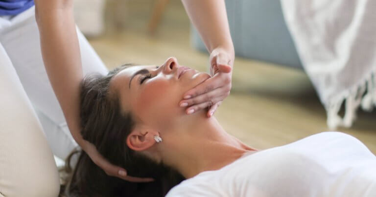 Woman receiving Gillespie Approach–Craniosacral Fascial Therapy