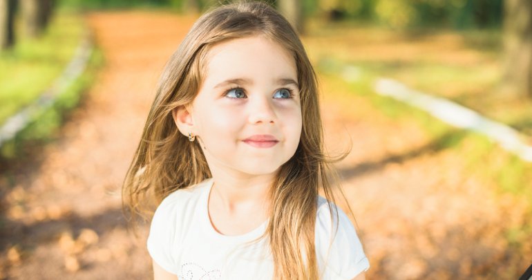 Quality-of-life issues - smiling little girl in park - Gillespie Approach–Craniosacral Fascial Therapy
