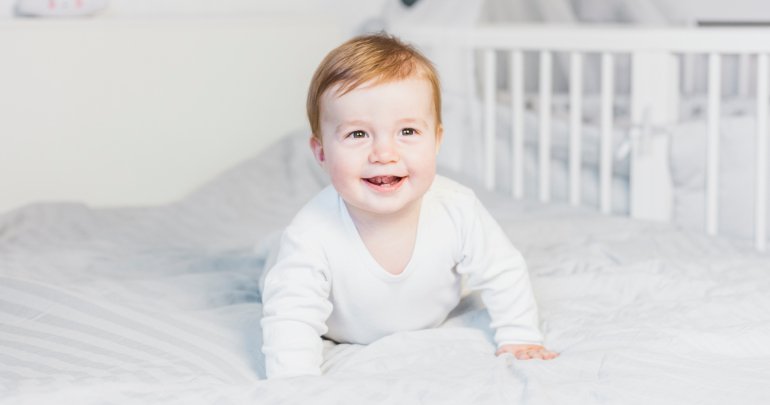 Practitioner helps son heal clubfoot - baby in bed - Gillespie Approach - Craniosacral Fascial Therapy