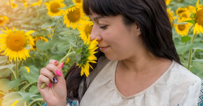 Fascial web remembers - woman smelling daisy - Gillespie Approach–Craniosacral Fascial Therapy