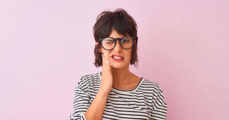 Dentists please take note - woman holding jaw - Gillespie Approach–Craniosacral Fascial Therapy