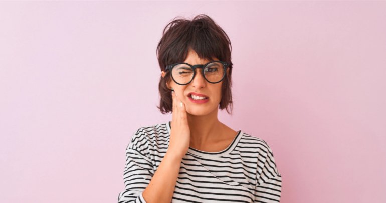 Dentists please take note - woman holding jaw - Gillespie Approach–Craniosacral Fascial Therapy