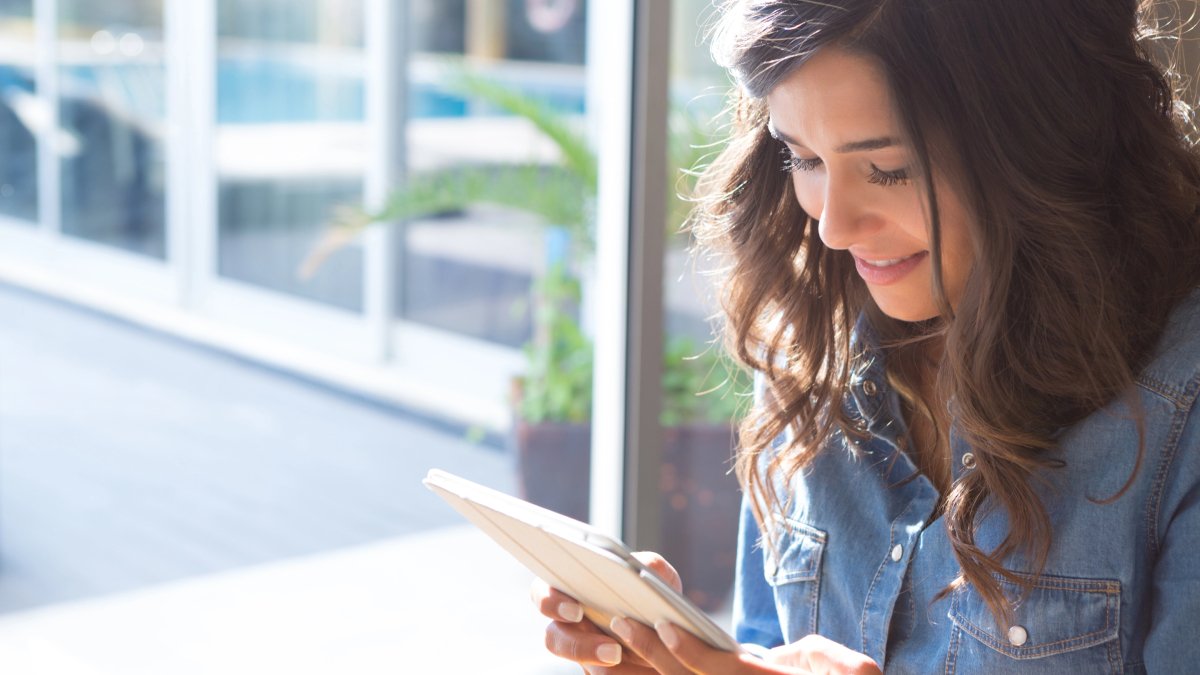 Follow the Gillespie Approach - woman reading on tablet computer - Gillespie Approach–Craniosacral Fascial Therapy